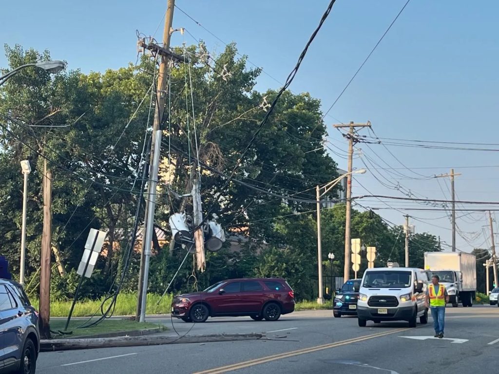 multiple cars in the area, a down telephone pole following a rollover crash in Hackensack